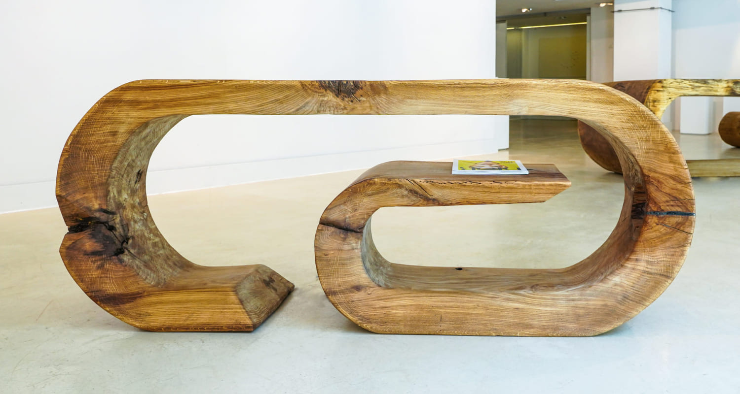 OZE sculptural wooden commode with integrated mid-level shelf in a bright minimalist gallery